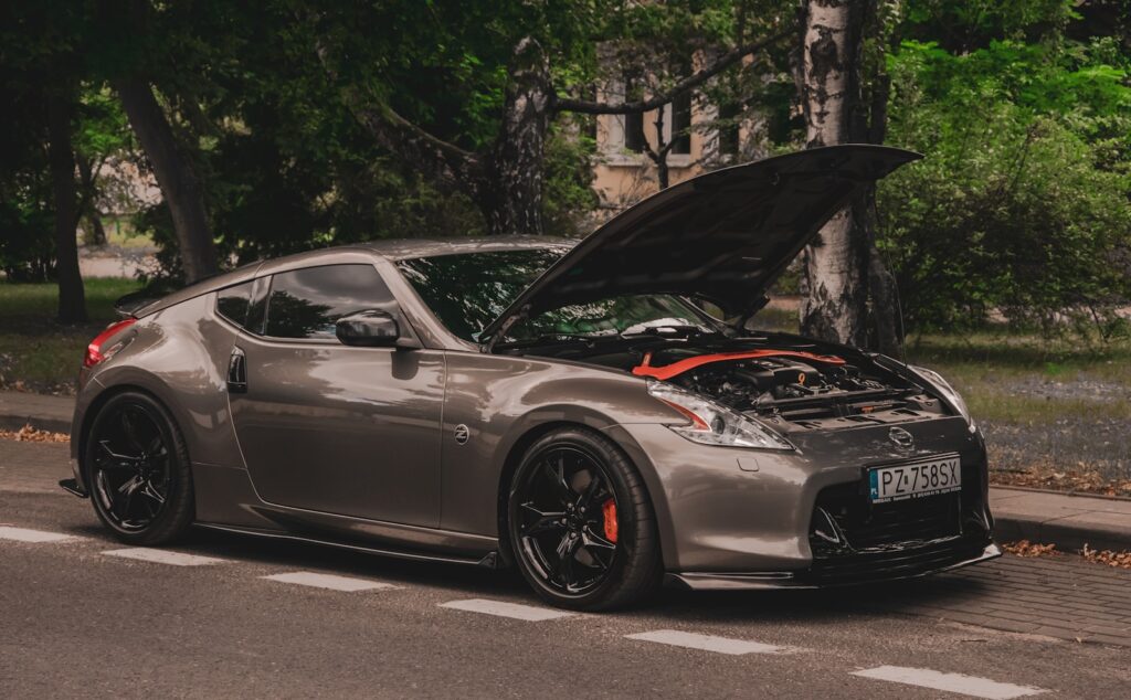 a silver sports car with its hood open