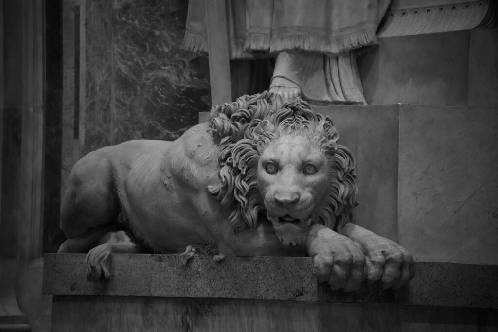 A black and white photo of a lion statue