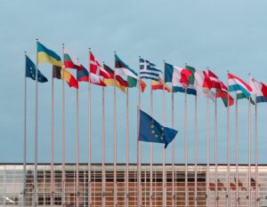 a bunch of flags that are in front of a building